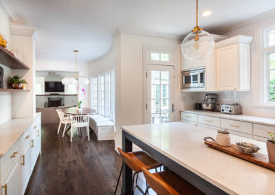 kitchen remodel simply white quartz brass curved banquette staircase remodel square baluster square newel post blue island