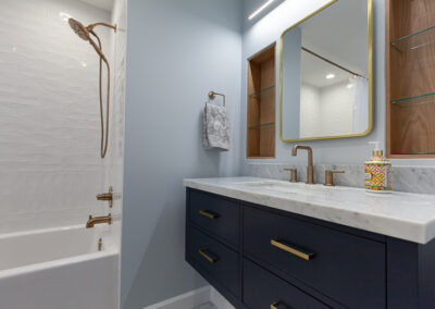 hall bathroom remodel, hall bathroom renovation, downers grove, illinois, hyland homes, navy vanity, recessed shelves, tiles wainscoting